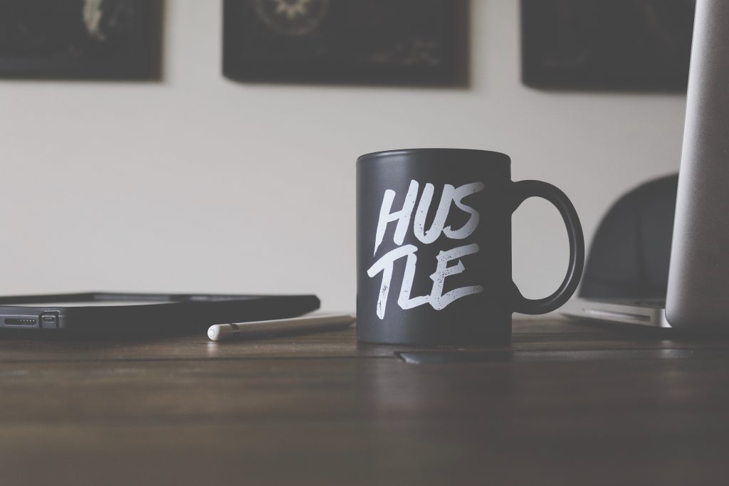 Image with a cup that says Hustle